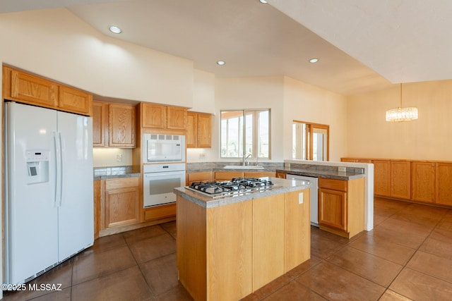 3655 N Harrison Rd, Tucson, AZ 85749 - kitchen with white appliances, a peninsula, a center island, dark tile patterned flooring, and a chandelier