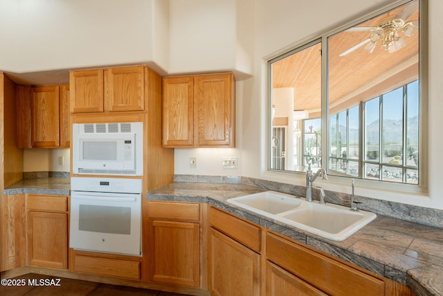 3655 N Harrison Rd, Tucson, AZ 85749 - kitchen with white appliances, ceiling fan, and tile countertops