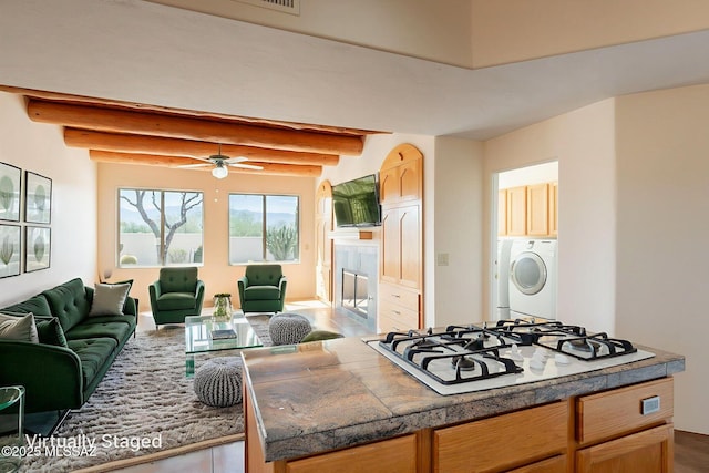 3655 N Harrison Rd, Tucson, AZ 85749 - kitchen with open floor plan, white gas stovetop, washing machine and dryer, a ceiling fan, and beam ceiling