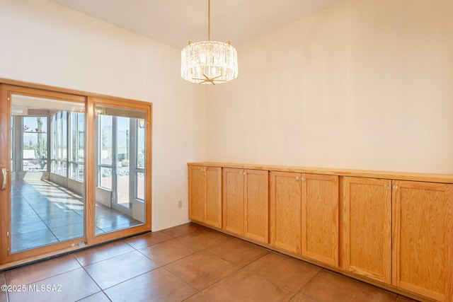 3655 N Harrison Rd, Tucson, AZ 85749 - spare room with a chandelier and light tile patterned flooring