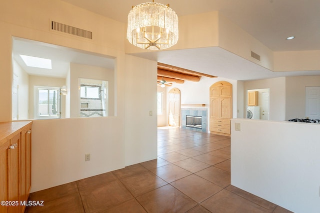 3655 N Harrison Rd, Tucson, AZ 85749 - kitchen featuring a tile fireplace, tile patterned floors, a chandelier, and open floor plan