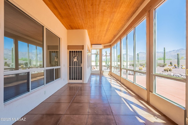 3655 N Harrison Rd, Tucson, AZ 85749 - unfurnished sunroom featuring wood ceiling, a mountain view, tile patterned flooring, and a wall mounted AC