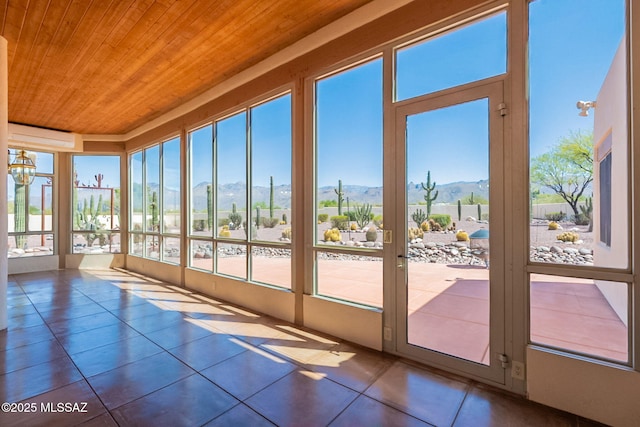 3655 N Harrison Rd, Tucson, AZ 85749 - unfurnished sunroom featuring wood ceiling, tile patterned flooring, a mountain view, and a wall mounted air conditioner