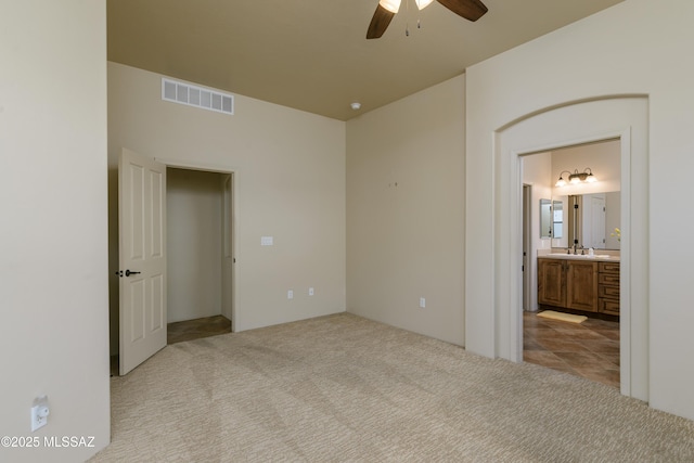 341 E Calderwood Rd, Tucson, AZ 85704 - unfurnished bedroom with carpet, ensuite bath, and ceiling fan