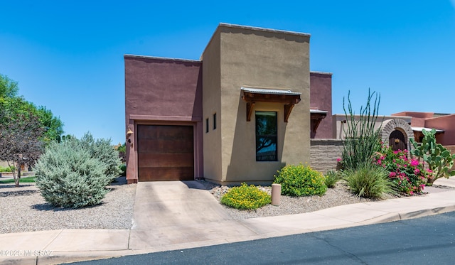 341 E Calderwood Rd, Tucson, AZ 85704 - pueblo-style home featuring stucco siding, concrete driveway, and an attached garage