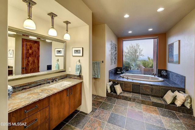 5254 W Saguaro Cliffs Dr, Tucson, AZ 85745 - bathroom with a bath, vanity, stone tile floors, and recessed lighting
