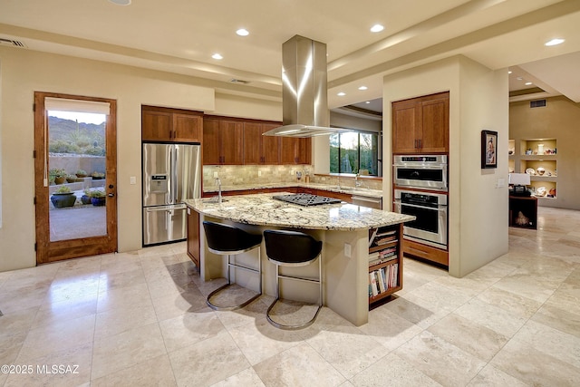 5254 W Saguaro Cliffs Dr, Tucson, AZ 85745 - kitchen featuring appliances with stainless steel finishes, island exhaust hood, backsplash, a kitchen island with sink, and recessed lighting