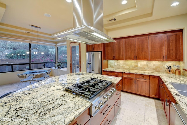 5254 W Saguaro Cliffs Dr, Tucson, AZ 85745 - kitchen featuring stainless steel appliances, island range hood, a tray ceiling, backsplash, and light stone countertops