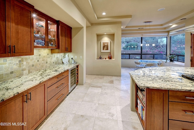 5254 W Saguaro Cliffs Dr, Tucson, AZ 85745 - kitchen with a raised ceiling, wine cooler, backsplash, and light stone countertops