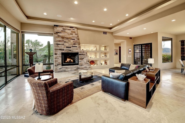 5254 W Saguaro Cliffs Dr, Tucson, AZ 85745 - living area with a tray ceiling, a fireplace, built in shelves, and recessed lighting