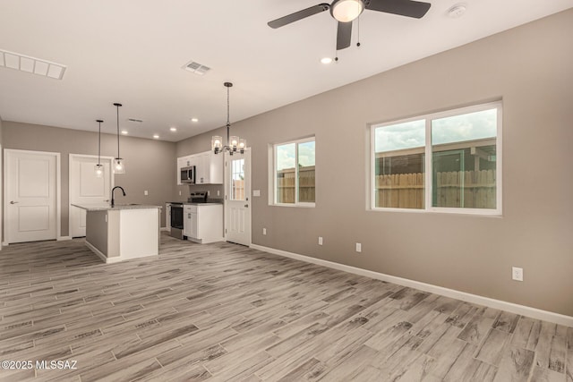 3710 S Bellingham Pl, Tucson, AZ 85730 - kitchen with stainless steel appliances, light wood finished floors, recessed lighting, white cabinetry, and ceiling fan