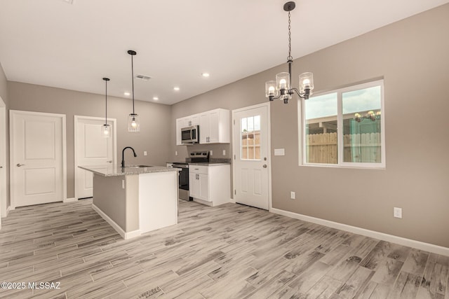 3710 S Bellingham Pl, Tucson, AZ 85730 - kitchen featuring stainless steel appliances, light wood-style floors, white cabinets, a chandelier, and recessed lighting