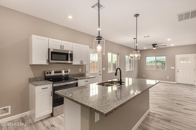 3710 S Bellingham Pl, Tucson, AZ 85730 - kitchen featuring stainless steel appliances, white cabinets, light wood-style flooring, stone counters, and recessed lighting