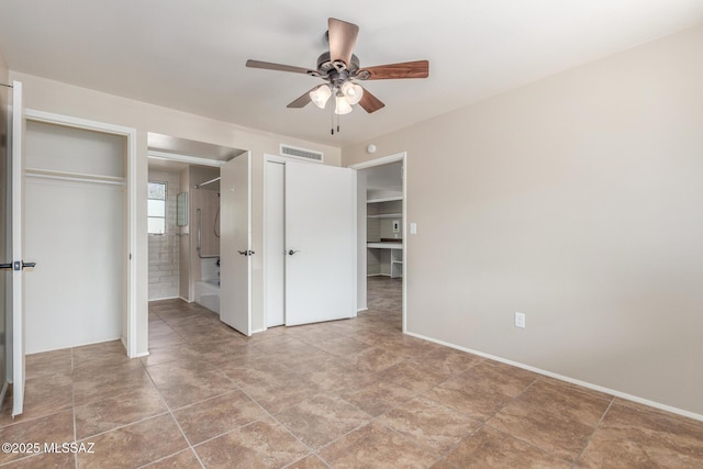 235 S Paseo Quinta Apt B, Green Valley, AZ 85614 - unfurnished bedroom featuring ensuite bathroom, multiple closets, and a ceiling fan