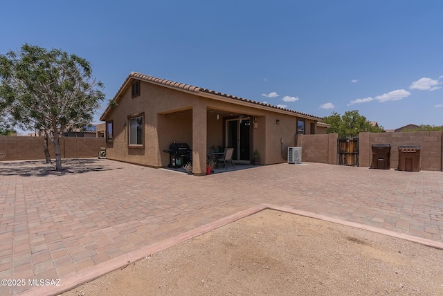 14199 N Bronze Statue Ave, Marana, AZ 85658 - rear view of property featuring stucco siding, a fenced backyard, a patio area, a tile roof, and a gate