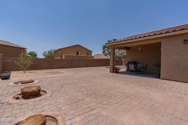 14199 N Bronze Statue Ave, Marana, AZ 85658 - fenced backyard with a patio area and an outdoor fire pit