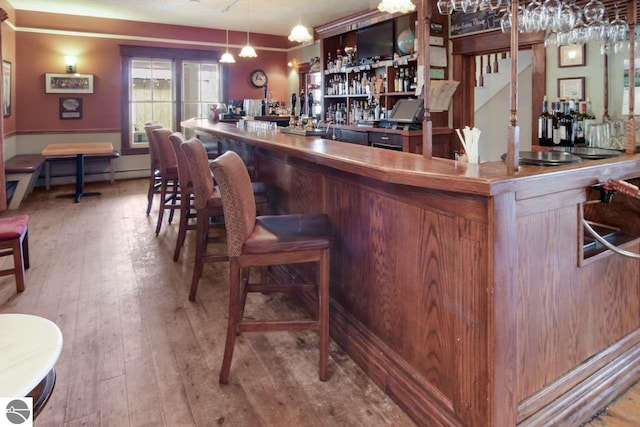 bar featuring light wood-type flooring