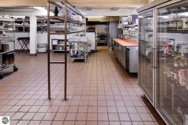 basement featuring tile flooring and stainless steel built in refrigerator