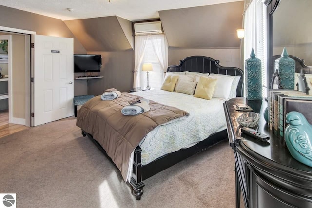 carpeted bedroom featuring vaulted ceiling and a wall mounted AC