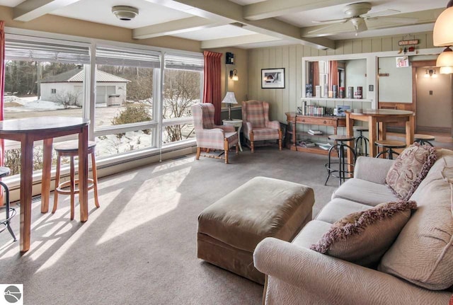 interior space featuring ceiling fan, a wealth of natural light, and beamed ceiling