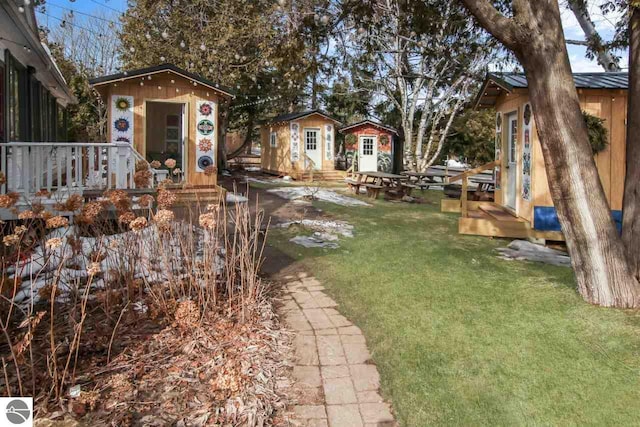 view of yard with a wooden deck and an outdoor structure