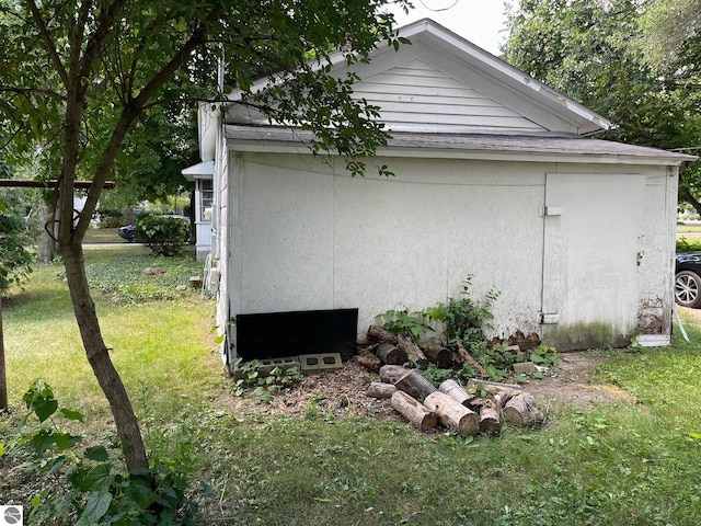 view of side of property with a yard