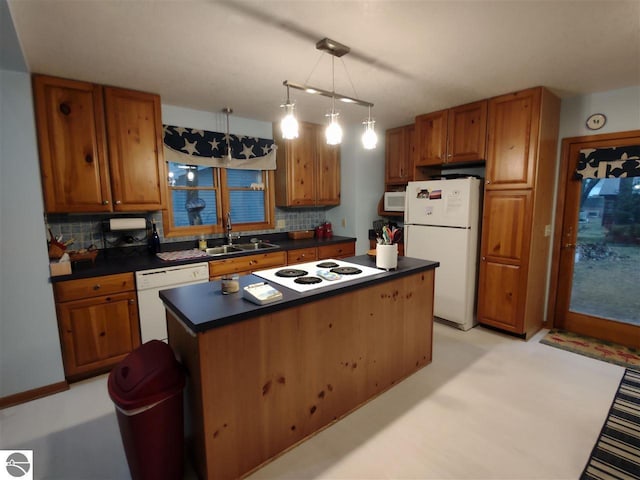 kitchen with sink, white appliances, hanging light fixtures, a center island, and tasteful backsplash