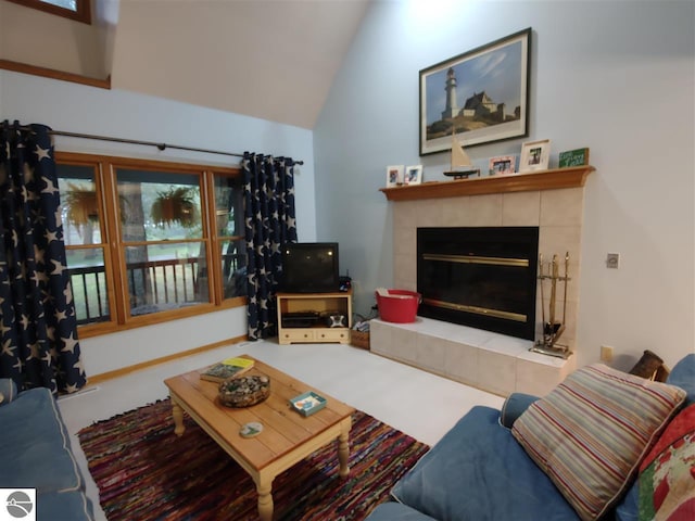 living room with vaulted ceiling and a tile fireplace