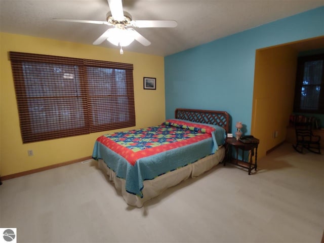 bedroom with ceiling fan and carpet floors