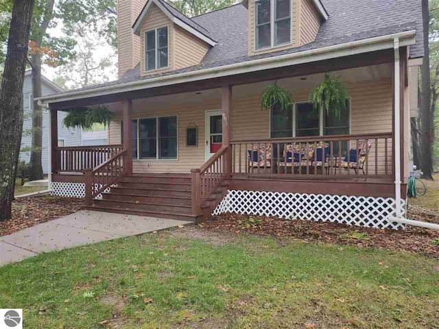 view of front of home with a porch and a front yard