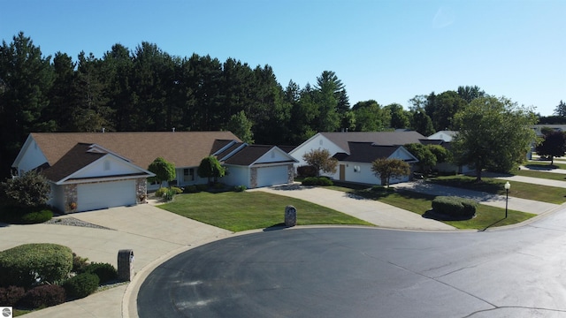 view of front of property featuring a front yard and a garage