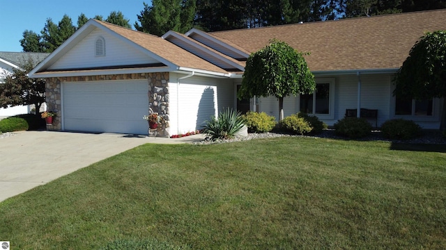 ranch-style house featuring a front lawn and a garage