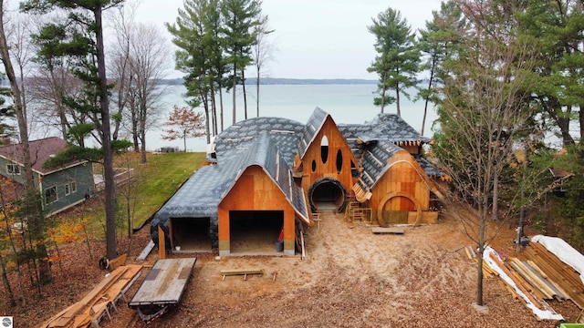 view of jungle gym featuring an outdoor structure and a water view