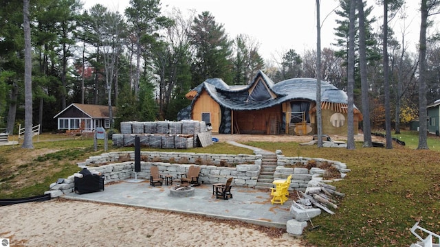 exterior space with a patio area and an outdoor fire pit