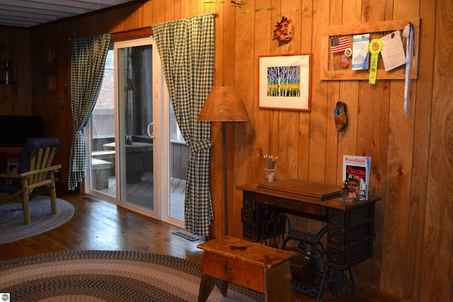 living room featuring wood walls and dark wood-type flooring