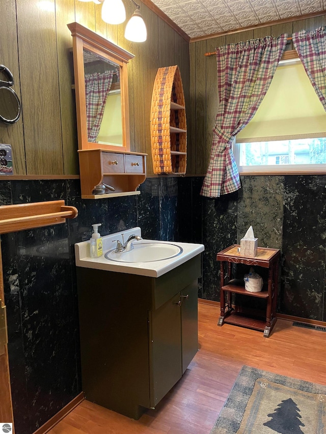 bathroom with backsplash, hardwood / wood-style floors, and oversized vanity