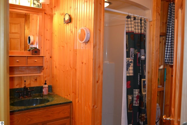 bathroom with large vanity and wood walls