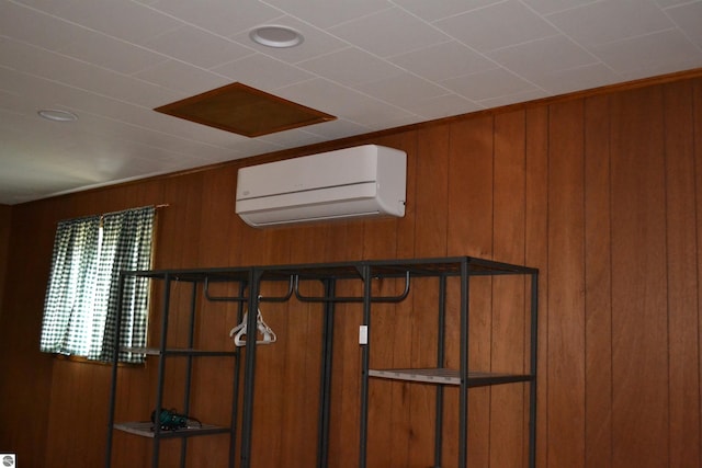 room details featuring wood walls and a wall mounted AC