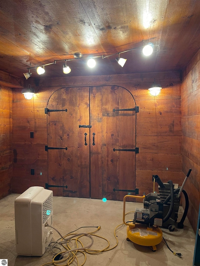 basement featuring wood walls