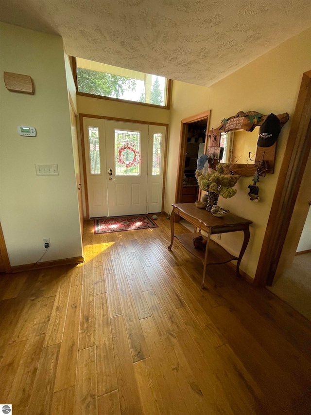 entrance foyer with a textured ceiling and light wood-type flooring