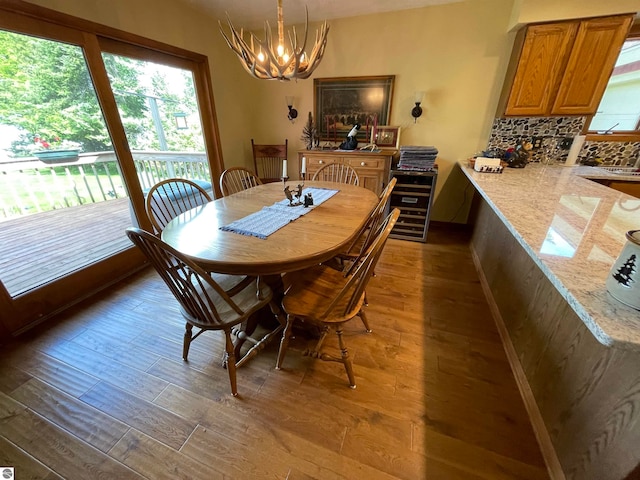 dining area featuring dark wood-type flooring and a chandelier