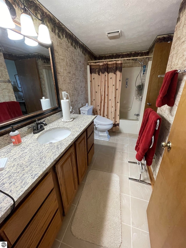 bathroom with toilet, a textured ceiling, tile flooring, and large vanity