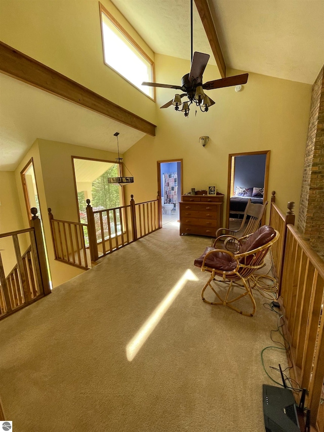 interior space featuring ceiling fan, high vaulted ceiling, beamed ceiling, and light carpet