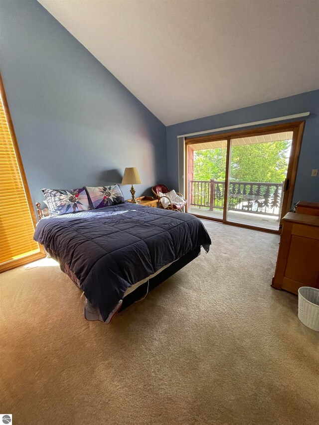 carpeted bedroom with access to outside and vaulted ceiling