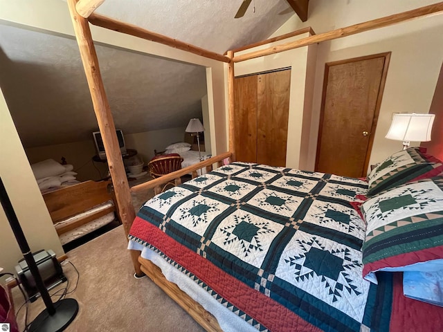 carpeted bedroom featuring ceiling fan, a closet, vaulted ceiling, and a textured ceiling