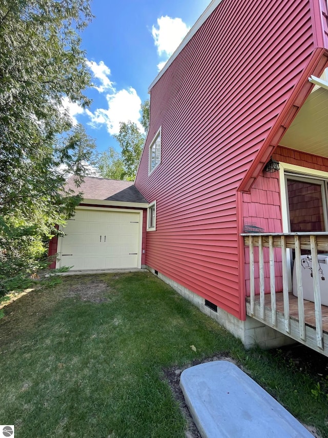 view of home's exterior with a garage and a lawn