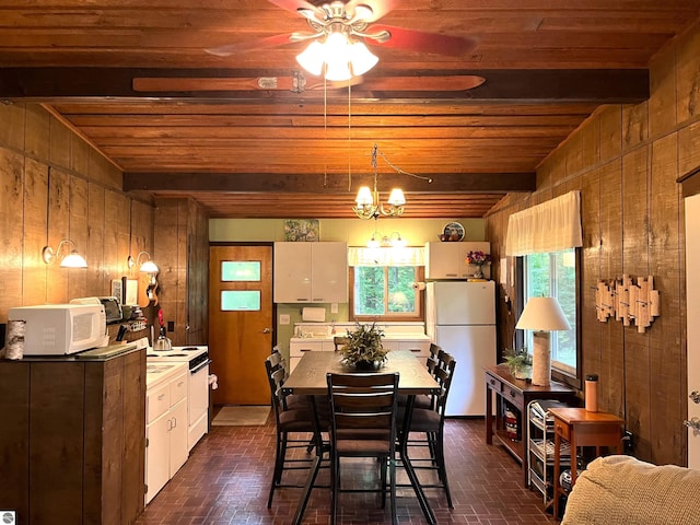 dining area with wood walls, wooden ceiling, ceiling fan with notable chandelier, and beamed ceiling