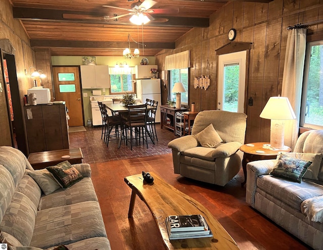 living room with wooden walls, ceiling fan, wood ceiling, dark hardwood / wood-style flooring, and vaulted ceiling with beams