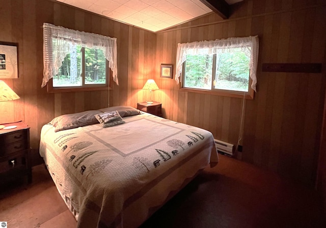 bedroom featuring lofted ceiling, wooden walls, and a baseboard radiator