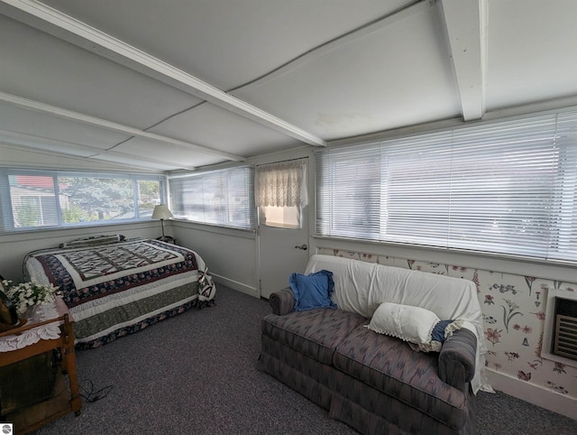 carpeted bedroom featuring beamed ceiling